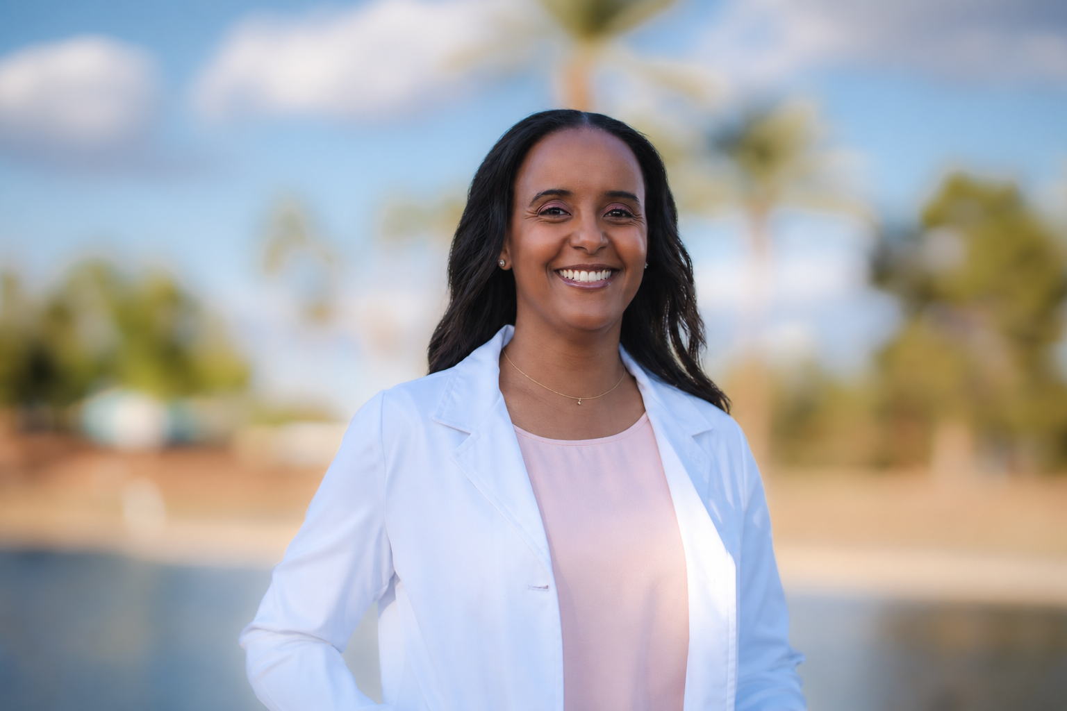 Dr. Leah Tekle smiling in her white coat